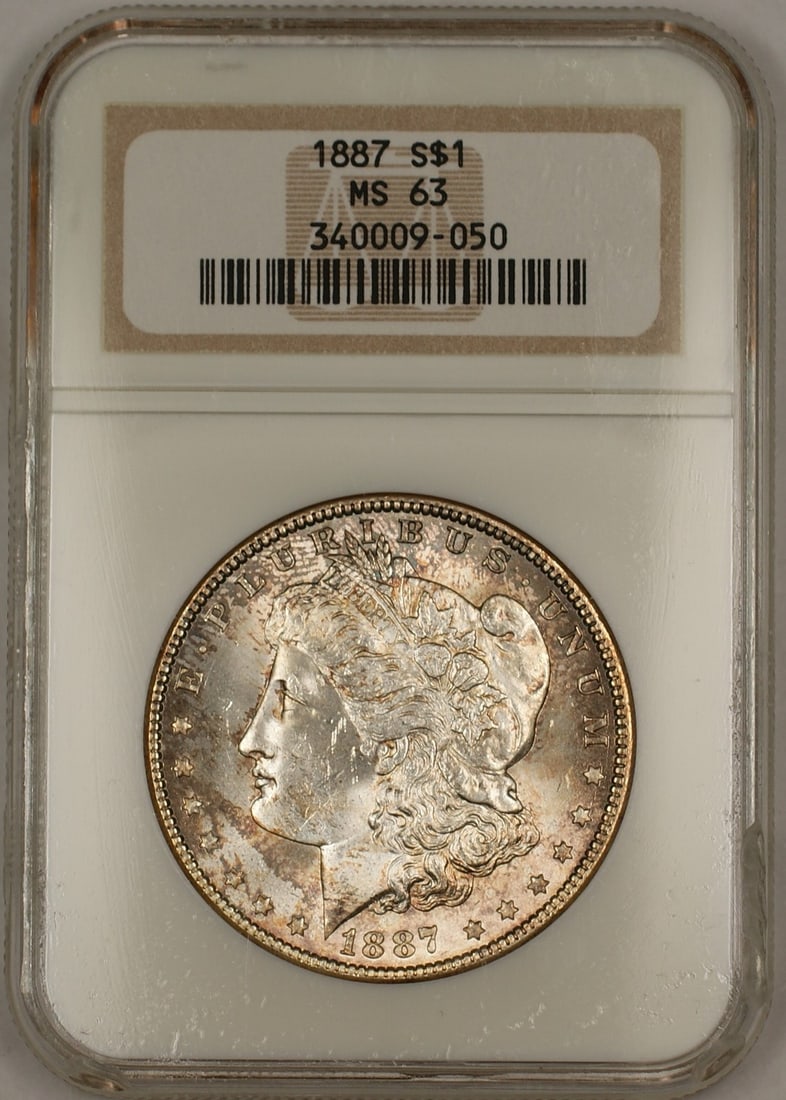NGC MS-63 1887 Silver Morgan Dollar Philadelphia Attractive Toning: NGC MS-63 1887 Silver Morgan Dollar Philadelphia Attractive Toning This is an 1887 Morgan Silver Dollar $1 coin graded MS-63 by NGC. The coin is uncirculated, features attractive toning especially on 
