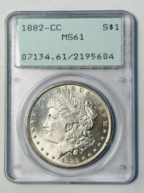 PCGS MS61 1882 CC Morgan Silver Dollar Carson City Rattler: PCGS MS61 1882 CC Morgan Silver Dollar Carson City Rattler Pre-owned 1882-CC Morgan Silver Dollar certified by PCGS and graded MS-61. This Carson City issue is housed in a rattler holder. Specificatio