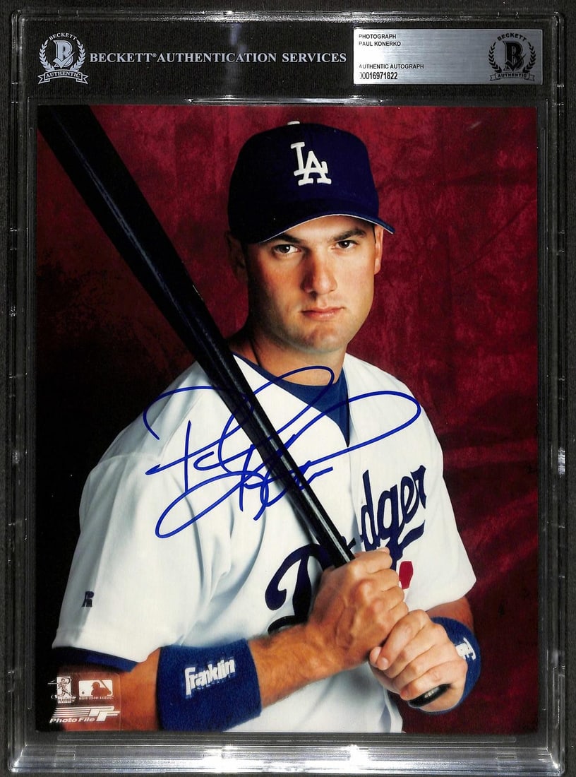 Beckett Authenticated Paul Konerko Signed 8x10 Dodgers Photo: Beckett Authenticated Paul Konerko Signed 8x10 Dodgers Photo This is an 8x10 photograph featuring Paul Konerko in his Los Angeles Dodgers uniform, hand-signed in bold blue ink. The autograph is encaps