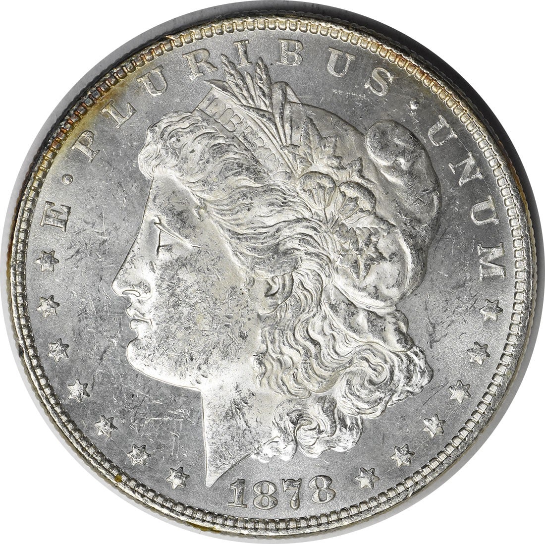 Brilliant Uncirculated 1878 Morgan Dollar 7 Tail Feathers Reverse Silver Coin: Brilliant Uncirculated 1878 Morgan Dollar 7 Tail Feathers Reverse Silver Coin This is an uncirculated 1878 Morgan Silver Dollar featuring the 7 Tail Feathers Reverse of 1878 design. The coin is compos