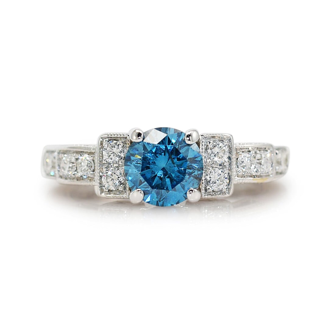 Vintage 18K White Gold Engagement Ring Blue Color Enhanced Diamond: Vintage 18K White Gold Engagement Ring Blue Color Enhanced Diamond Pre-owned vintage engagement ring crafted in 18k white gold with a color-enhanced natural diamond center and diamond side stones. The