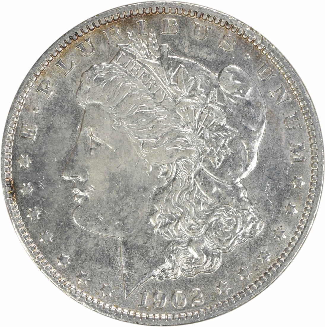 1902 Morgan Silver Dollar AU Uncertified 90% Silver Coin: 1902 Morgan Silver Dollar AU Uncertified 90% Silver Coin This 1902 Morgan Silver Dollar is an exquisite piece, showcasing a grade of AU (About Uncirculated). Minted in Philadelphia, this coin features
