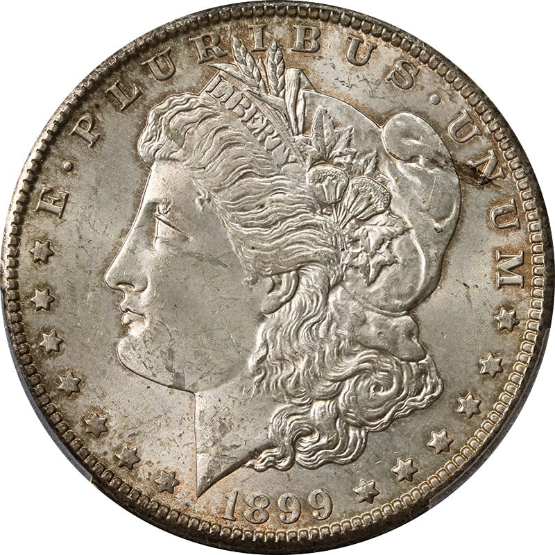 PCGS MS63 1899-O Silver Morgan Dollar with Colorful Toning: PCGS MS63 1899-O Silver Morgan Dollar with Colorful Toning This 1899-O Morgan Silver Dollar is graded MS63 by PCGS and features attractive toning. Struck at the New Orleans Mint, this uncirculated coi