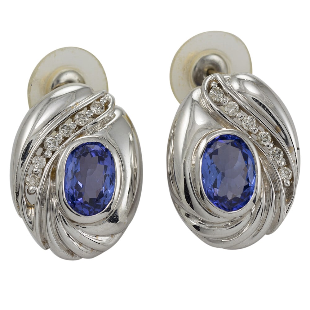 14K White Gold Dangle Drop Earrings with Tanzanite and Diamonds: 14K White Gold Dangle Drop Earrings with Tanzanite and Diamonds These elegant dangle/drop earrings feature two oval tanzanite gemstones with a combined weight of 3.00 carats, set in 14K white gold. Ac