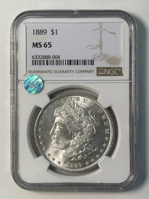 NGC MS 65 1889 Morgan Silver Dollar Sight White: NGC MS 65 1889 Morgan Silver Dollar Sight White 1889 Morgan Silver Dollar graded MS 65 by NGC. This pre-owned coin is described as Sight White and features a classic Morgan Dollar design struck in sil