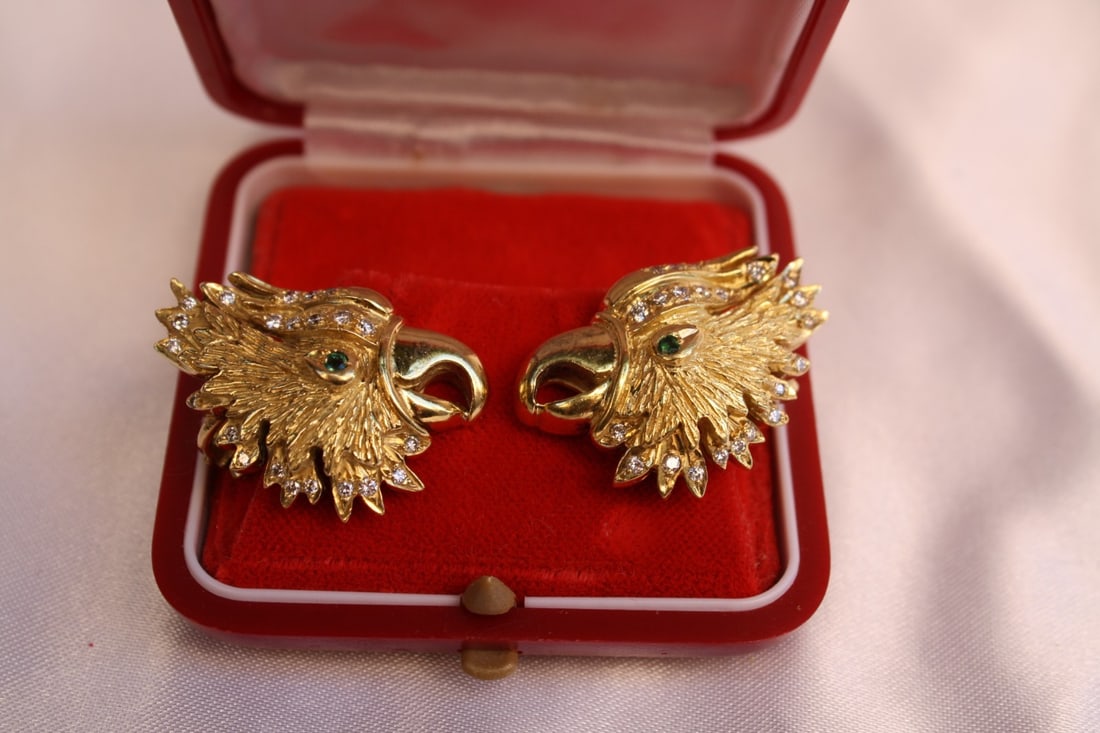 Stunning 18K Gold Emerald Diamond Hoop Earrings: Stunning 18K Gold Emerald Diamond Hoop Earrings This stunning pair of earrings features a beautiful combination of 18K yellow gold, diamonds, and emeralds. Each earring is adorned with two vibrant eme
