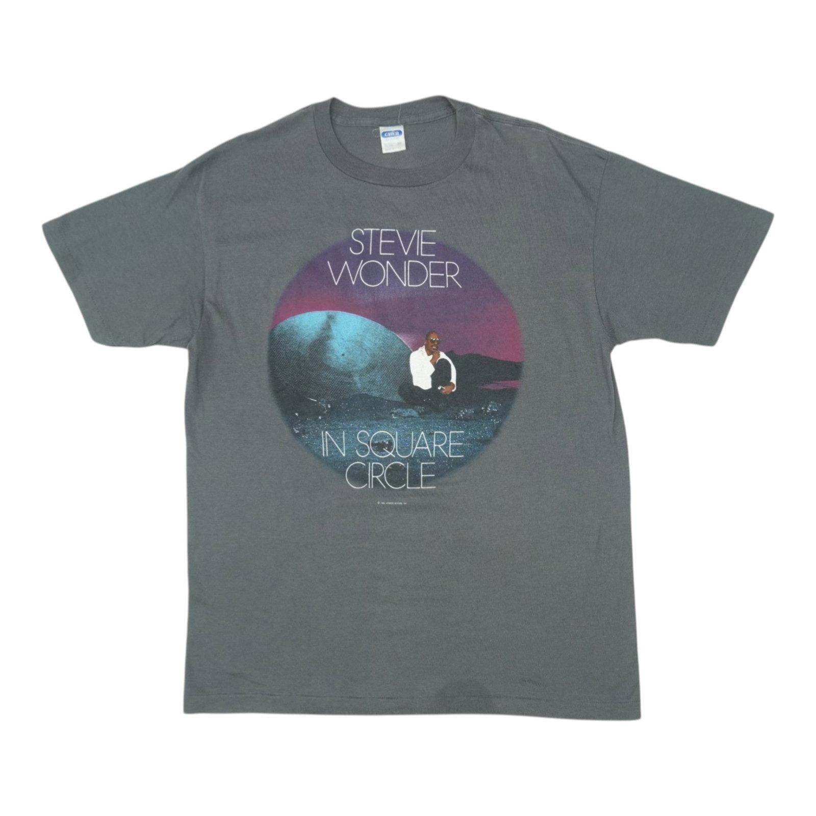 Vintage 1986 Stevie Wonder Grey Poly Cotton XL Shirt: Vintage 1986 Stevie Wonder Grey Poly Cotton XL Shirt This is an original vintage 1986 Stevie Wonder "In Square Circle" shirt made from a 50/50 polyester and cotton blend. The shirt is grey in color an