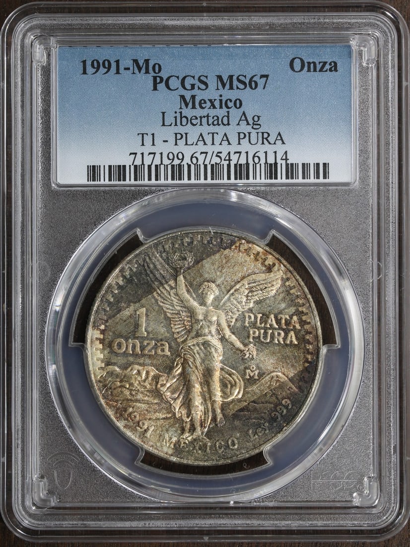 Mexico 1991-Mo Silver Libertad Onza 1 oz MS67 PCGS Color: Mexico 1991-Mo Silver Libertad Onza 1 oz MS67 PCGS Color 1991-Mo Mexico Silver Libertad Onza coin with color finish, graded MS67 by PCGS. This pre-owned coin contains 1 oz of .999 fine silver and was 