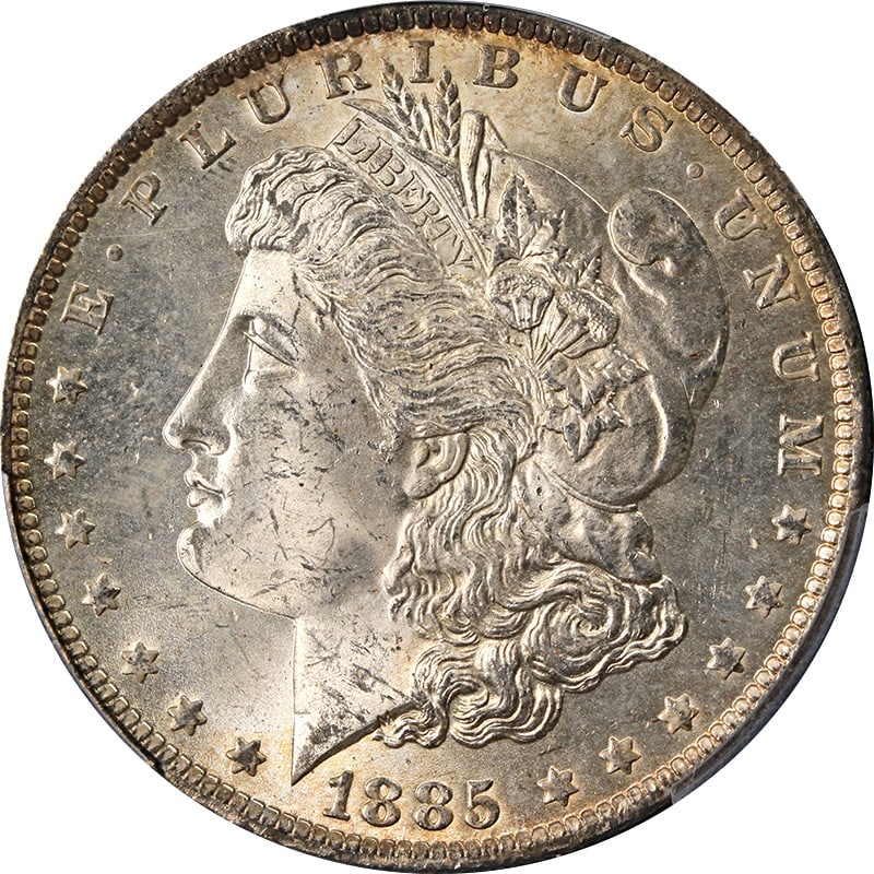 PCGS MS64 1885-O Morgan Dollar with Colorful Toning: PCGS MS64 1885-O Morgan Dollar with Colorful Toning This 1885-O Morgan Silver Dollar is certified by PCGS with a grade of MS64 and features attractive toning. Struck at the New Orleans Mint, this unci
