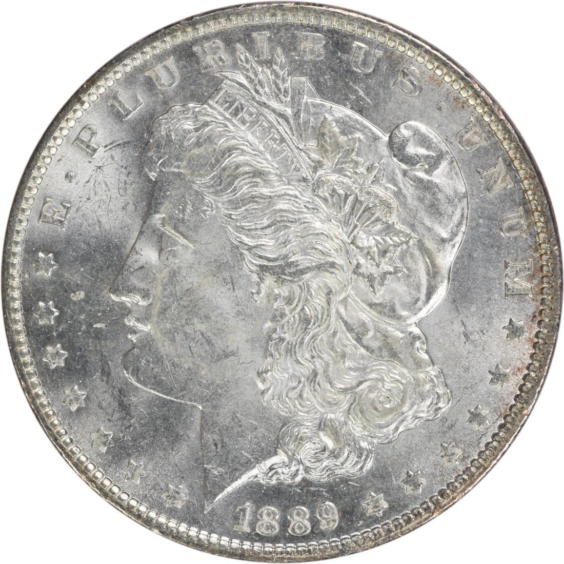 1889 Morgan Dollar Silver Coin Brilliant Uncirculated Uncertified: 1889 Morgan Dollar Silver Coin Brilliant Uncirculated Uncertified This 1889 Morgan Silver Dollar is in brilliant uncirculated condition and remains uncertified. Minted in the United States with no min