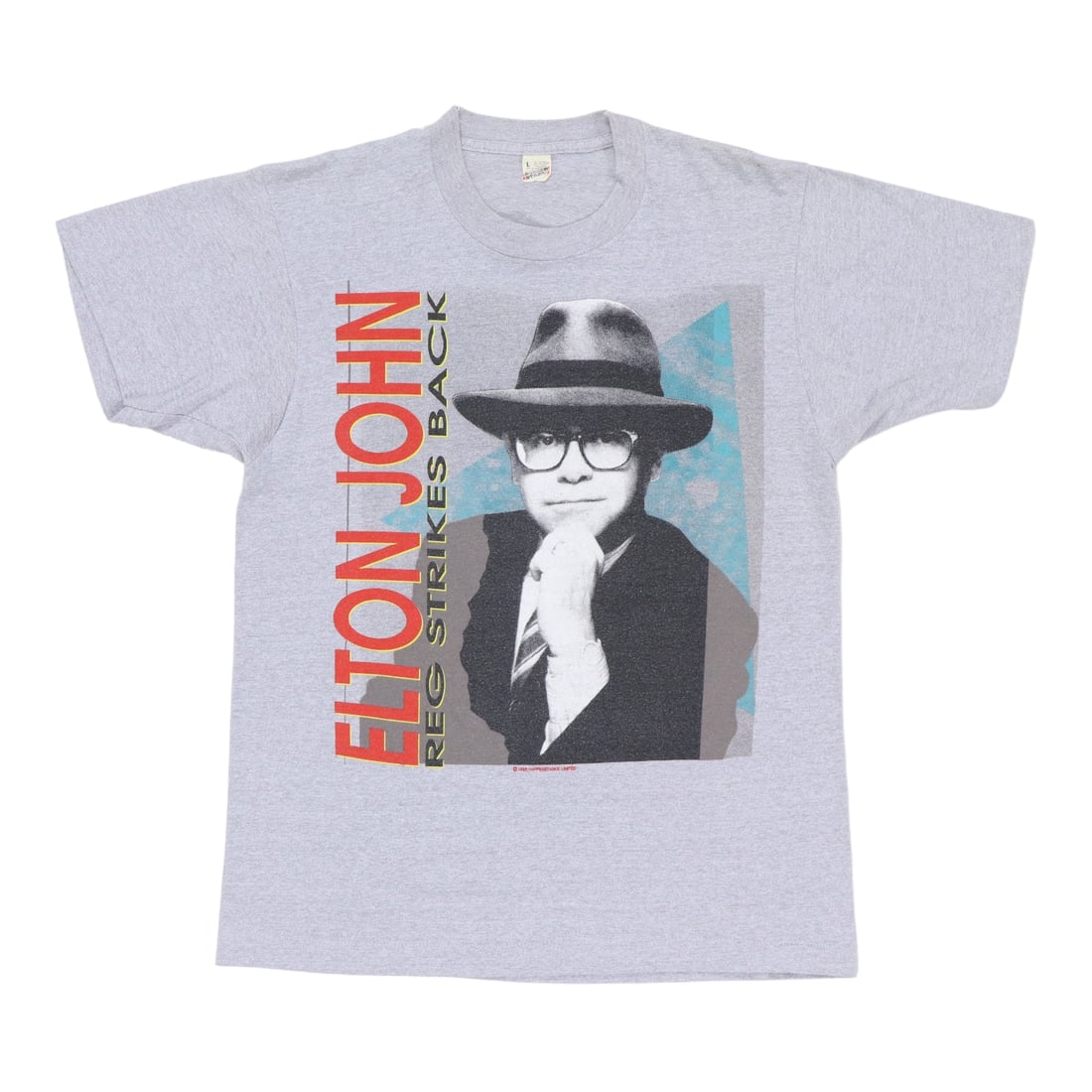 Vintage 1986 Reg Strikes Back Elton John Gray T Shirt Poly Cotton: Vintage 1986 Reg Strikes Back Elton John Gray T Shirt Poly Cotton This is an original vintage 1986 Elton John 'Reg Strikes Back' shirt. The shirt is not a modern reproduction and features no back grap