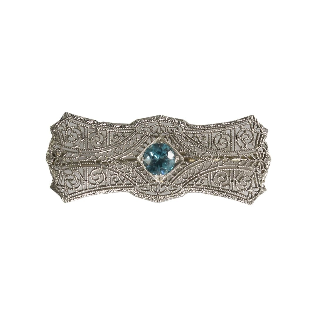 Antique Blue Spinel Filigree Brooch in 14K White Gold Platinum: Antique Blue Spinel Filigree Brooch in 14K White Gold Platinum Antique brooch crafted in platinum and 14k white gold, featuring a natural light blue round spinel at the center. The design showcases de