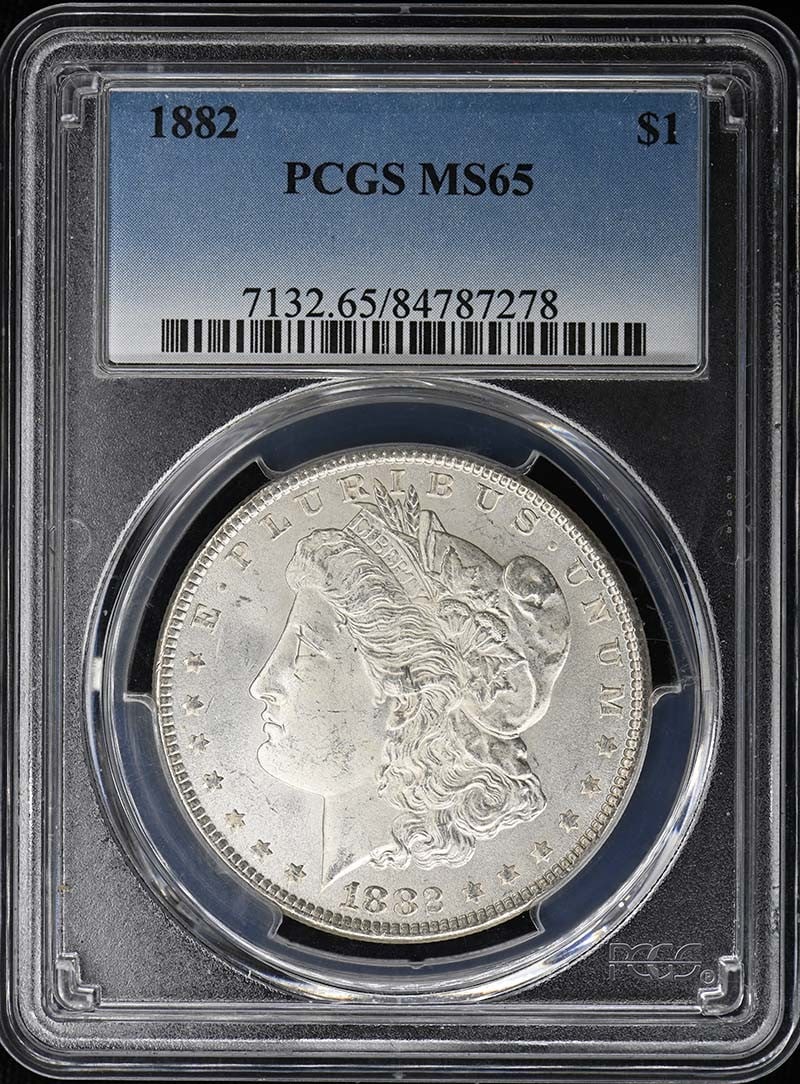 PCGS MS65 1882 Morgan Silver Dollar $1: PCGS MS65 1882 Morgan Silver Dollar $1 1882 Morgan Dollar certified by PCGS and graded MS65. This uncirculated United States silver dollar is a pre-owned coin from the Philadelphia Mint. Specification