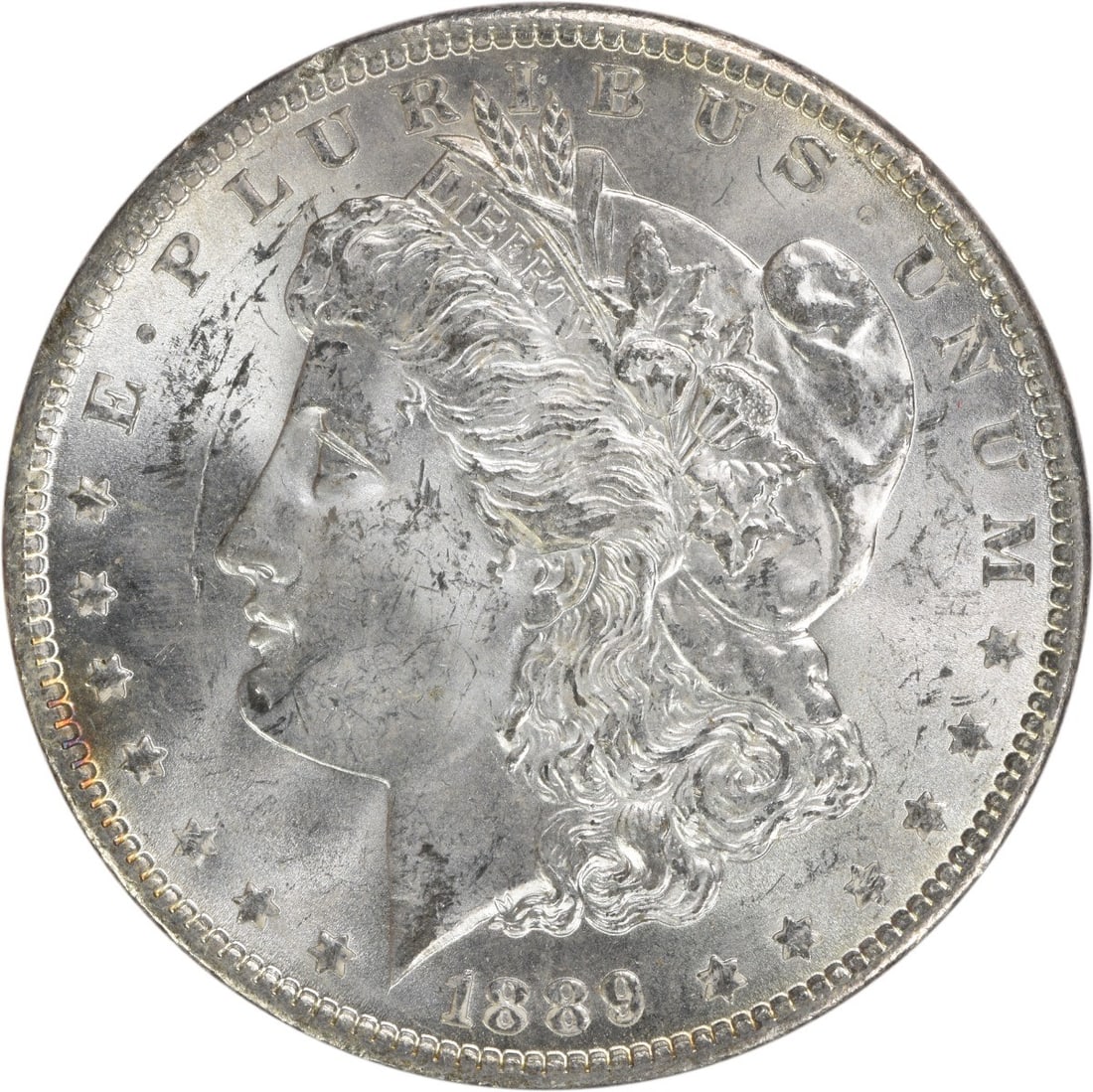 Uncirculated 1889 Silver Dollar Morgan Type Brilliant Uncertified Example: Uncirculated 1889 Silver Dollar Morgan Type Brilliant Uncertified Example This is an uncirculated 1889 Morgan Silver Dollar from the United States. The coin is composed of silver and features no mint 