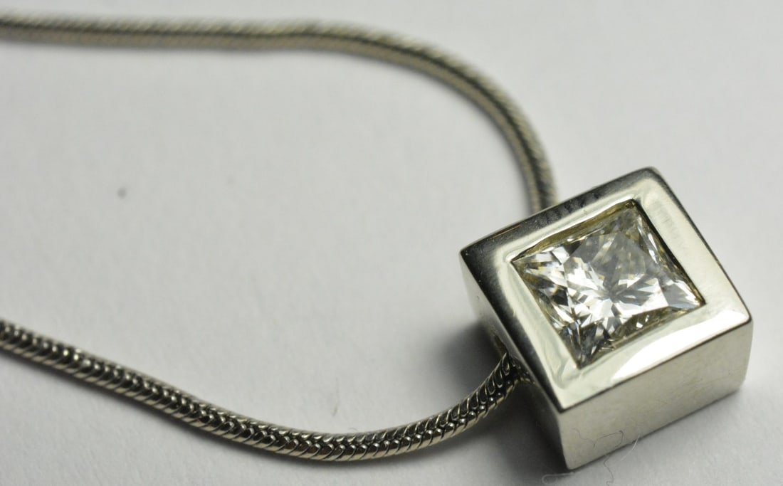 Princess Cut Diamond Solitaire Necklace 14K White Gold 16 in: Princess Cut Diamond Solitaire Necklace 14K White Gold 16 in This elegant necklace features a 0.65 carat princess cut diamond solitaire set in 14k white gold. The diamond displays an H to I color grad