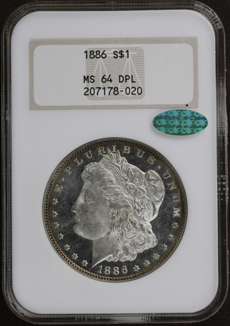 NGC MS64 DMPL CAC 1886 Morgan Silver Dollar Philadelphia: NGC MS64 DMPL CAC 1886 Morgan Silver Dollar Philadelphia 1886 Morgan Silver Dollar in a Numismatic Guaranty Company old fatty holder. This pre-owned coin carries a Mint State 64 grade with DMPL and CA