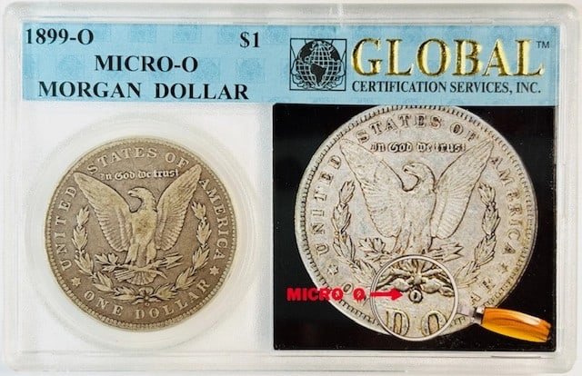 1899 Micro O Silver Dollar from New Orleans Mint in Holder: 1899 Micro O Silver Dollar from New Orleans Mint in Holder This 1899 O Morgan Silver Dollar features the rare Micro O variety, minted in New Orleans. Composed of silver, it is housed in a global holde