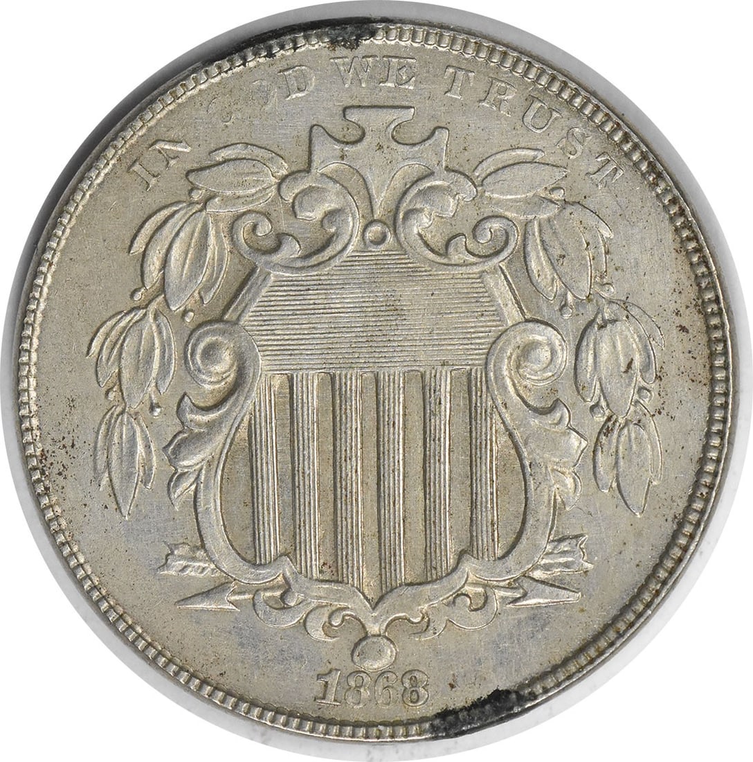 United States 1868 Shield 5C Nickel AU Uncertified: United States 1868 Shield 5C Nickel AU Uncertified 1868 Shield nickel in About Uncirculated (AU) grade. This pre-owned United States 5-cent coin is an uncertified, circulated example of the Shield typ