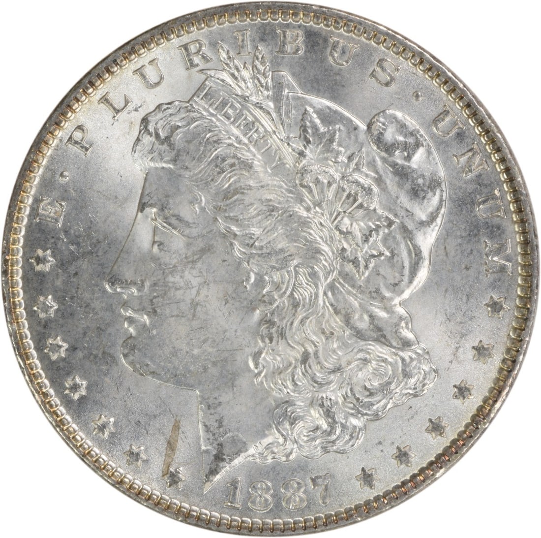 Choice BU 1887 Morgan Silver Dollar Uncirculated Uncertified Example: Choice BU 1887 Morgan Silver Dollar Uncirculated Uncertified Example This 1887 Morgan Silver Dollar is a Choice Brilliant Uncirculated example, featuring no mint mark. It is composed of silver and rem