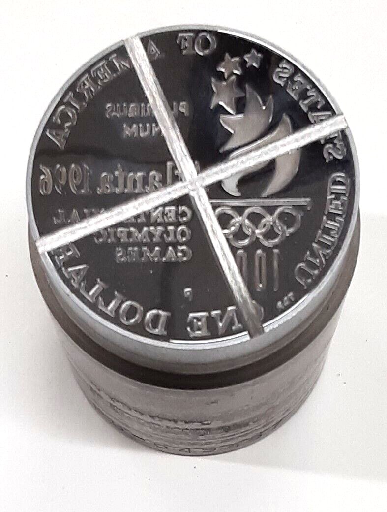 1996-P Olympic Proof Silver Dollar U.S. Mint Die With Defaced Design and COA: 1996-P Olympic Proof Silver Dollar U.S. Mint Die With Defaced Design and COA This is an official U.S. Mint die used for striking the 1996-P Olympic Proof Silver Dollar. The die features a defaced imag
