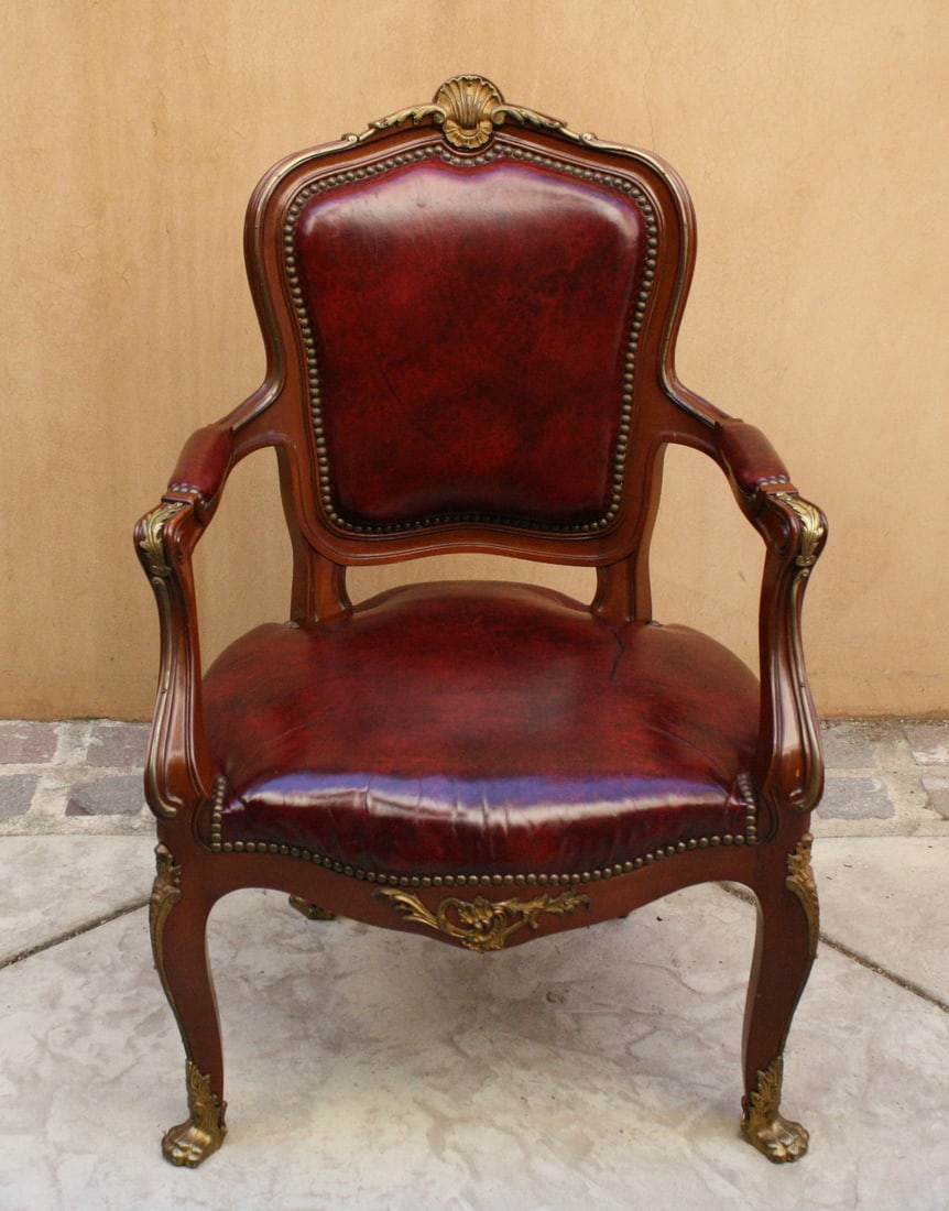 19th Century French Cherry Wood Leather Library Armchair with Bronze Accents: 19th Century French Cherry Wood Leather Library Armchair with Bronze Accents This exquisite late 19th century French armchair is a stunning piece crafted from cherry wood, featuring a luxurious leathe