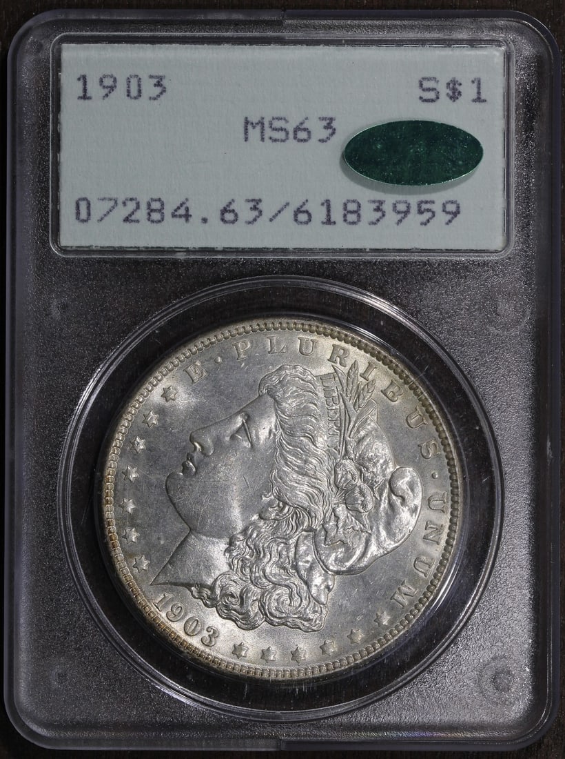 PCGS CAC MS63 1903 Morgan Dollar Silver Coin Philadelphia Rattler Holder: PCGS CAC MS63 1903 Morgan Dollar Silver Coin Philadelphia Rattler Holder This 1903 Morgan Silver Dollar features a fineness of 0.9 and was minted in Philadelphia. Graded MS63 by PCGS and approved by C