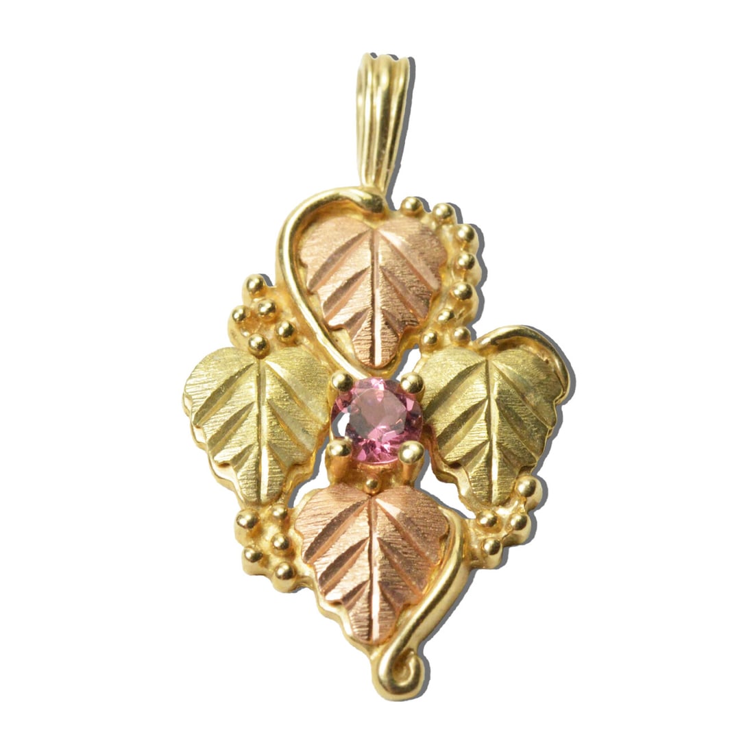 Pink Stone 10k Yellow Gold Black Hills Style Pendant 1.25 in: Pink Stone 10k Yellow Gold Black Hills Style Pendant 1.25 in This pendant features a pink oval-shaped stone set in 10k yellow gold, designed in the Black Hills style. The pendant measures 1.25 inches 