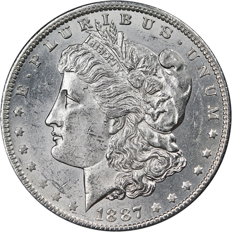 1887 O Morgan Dollar Bright White Nice BU+: 1887 O Morgan Dollar Bright White Nice BU+ This 1887-O Morgan Silver Dollar is an uncirculated coin featuring bright white luster, attractive eye appeal, and a well-defined strike. The coin is compose