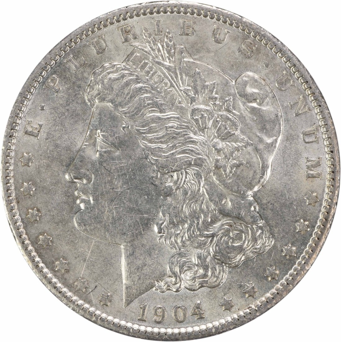 1904 Morgan Silver Dollar AU Uncertified 90% Silver Coin: 1904 Morgan Silver Dollar AU Uncertified 90% Silver Coin This 1904 Morgan Silver Dollar is a beautiful example of American numismatic history. Featuring the renowned design by George T. Morgan, this c