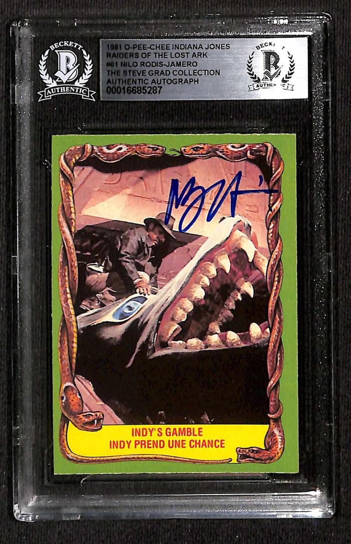 Beckett Slabbed 1981 O-Pee-Chee Indiana Jones Card Signed by Nilo Rodis-Jamero: Beckett Slabbed 1981 O-Pee-Chee Indiana Jones Card Signed by Nilo Rodis-Jamero This 1981 O-Pee-Chee "Indiana Jones and the Raiders of the Lost Ark" trading card features the authentic signature of Nil