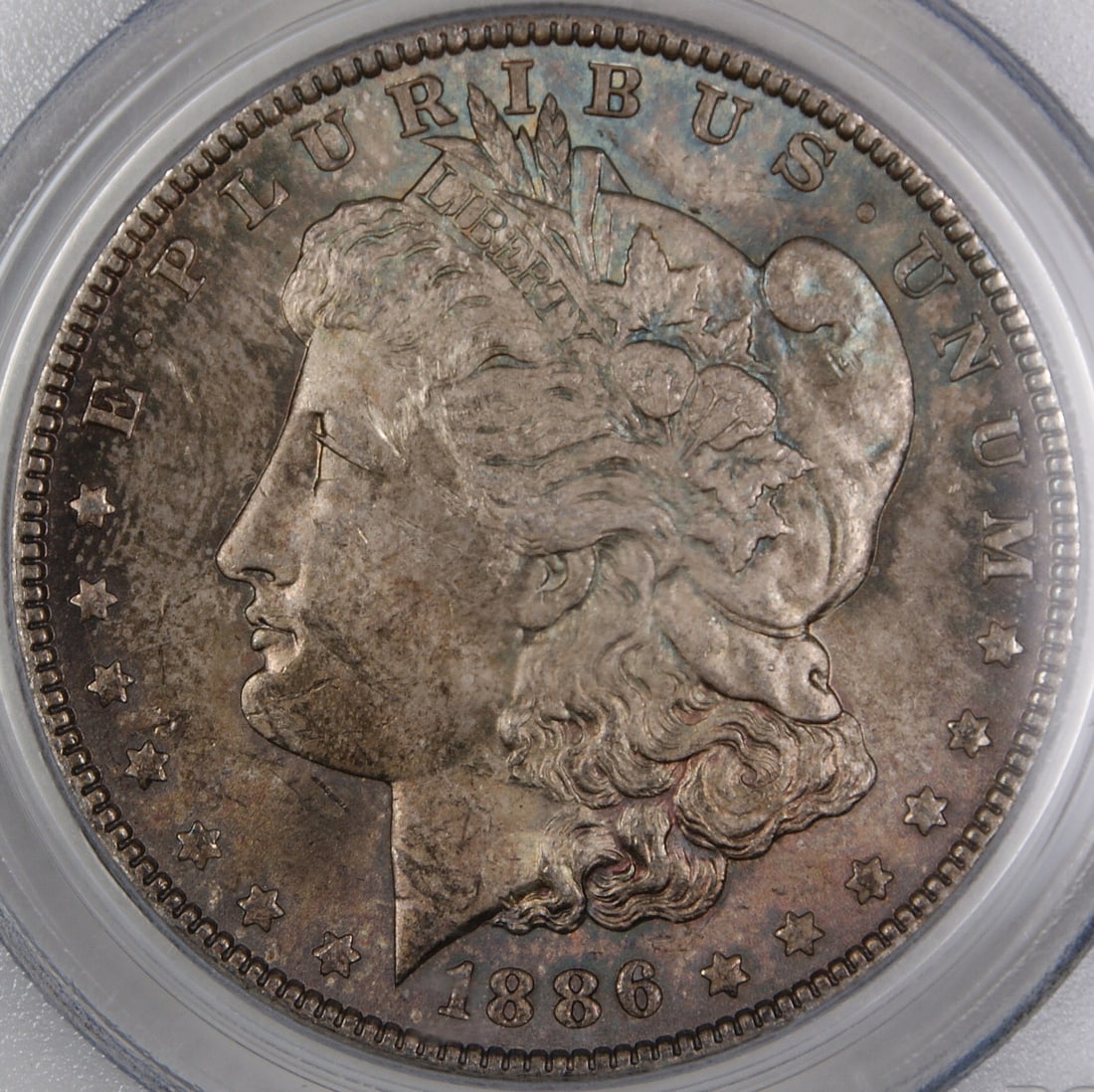 PCGS MS-62 1886 Morgan Dollar Philadelphia Toned Silver: PCGS MS-62 1886 Morgan Dollar Philadelphia Toned Silver This 1886 Morgan Silver Dollar is an uncirculated coin graded MS-62 by PCGS. It features attractive toning and was minted in Philadelphia. Compo