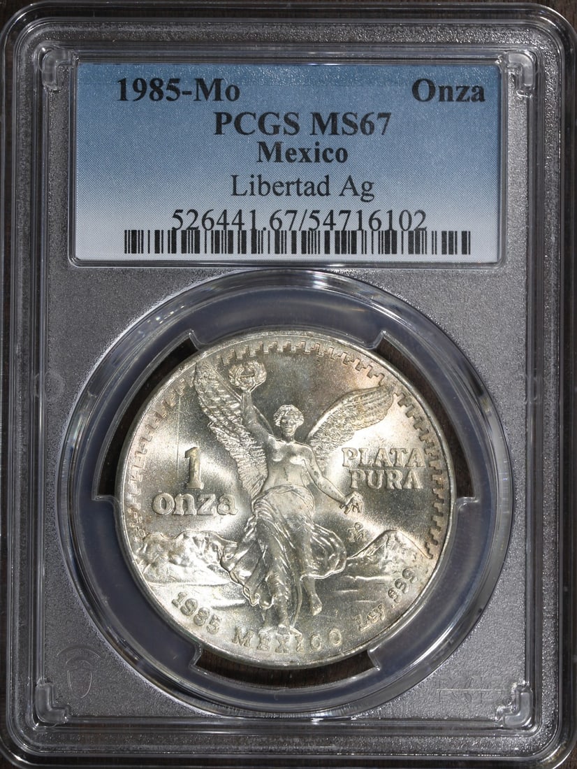 PCGS MS67 1985-Mo Mexico Silver Libertad Onza 1 oz Coin: PCGS MS67 1985-Mo Mexico Silver Libertad Onza 1 oz Coin 1985 Mexico 1 oz Silver Libertad Onza coin graded MS 67 by PCGS. It is composed of 0.999 fine silver and was minted by the Mexican Mint. The coi