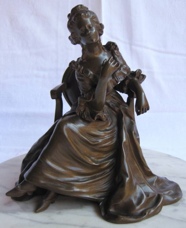 19th Century French Bronze Figurine Woman on Revolving Marble Base: 19th Century French Bronze Figurine Woman on Revolving Marble Base This exquisite 19th Century French Bronze Figurine features a young woman elegantly seated in a formal dress, showcasing intricate cr