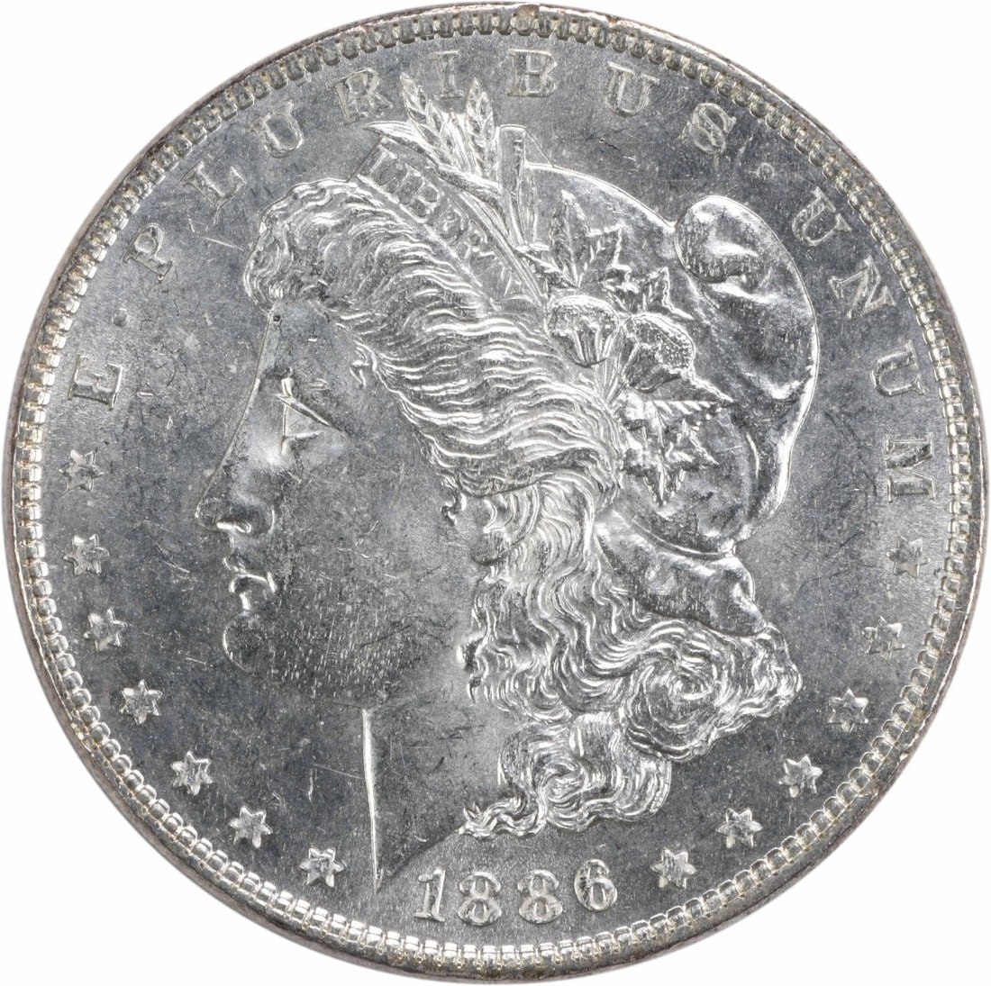 Brilliant Uncirculated 1886 Silver Dollar Morgan Type Uncertified No Mint Mark: Brilliant Uncirculated 1886 Silver Dollar Morgan Type Uncertified No Mint Mark This 1886 Morgan Silver Dollar is an uncirculated coin featuring a brilliant uncirculated (BU) grade. Composed of silver,