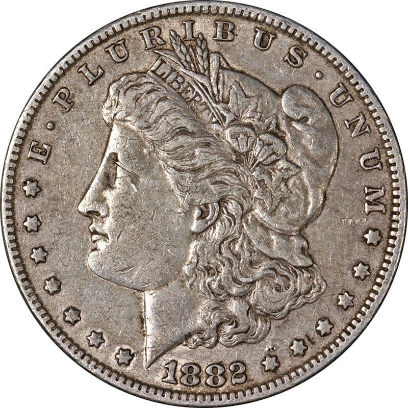 1882 P Morgan Dollar Silver US Coin Circulated: 1882 P Morgan Dollar Silver US Coin Circulated An 1882-P Morgan Silver Dollar in circulated condition. This silver coin is uncertified, with a fineness of 0.9 and origin in the United States. It is li
