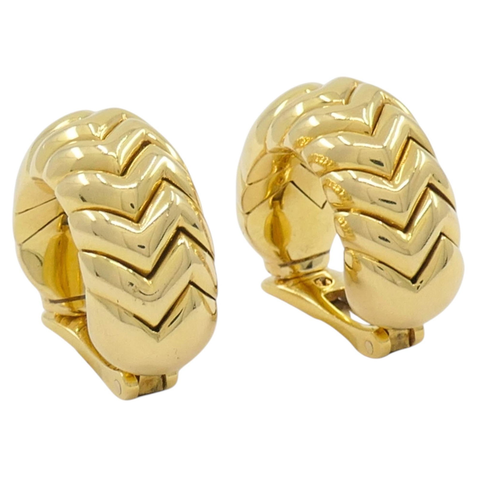 Bvlgari Spiga 18k Gold Clip On Huggie Earrings Pair: Bvlgari Spiga 18k Gold Clip On Huggie Earrings Pair A pair of Bvlgari Bulgari clip-on earrings from the Spiga collection, crafted in 18k gold. These earrings feature the collection's signature chevron