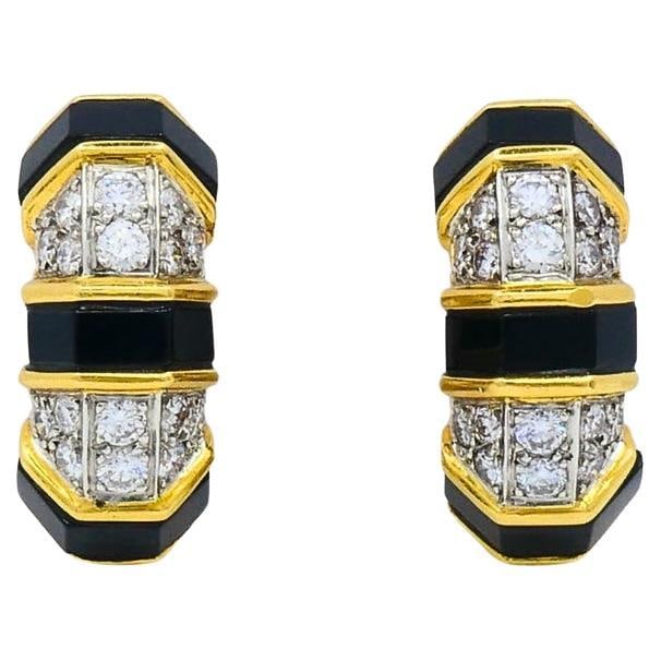 Tiffany Co 18K Yellow Gold Clip On Hoop Earrings with Onyx and Diamonds: Tiffany Co 18K Yellow Gold Clip On Hoop Earrings with Onyx and Diamonds A pair of Tiffany & Co. clip-on hoop earrings from the 1980s, featuring diamonds and onyx set in 18k yellow gold. The design inc