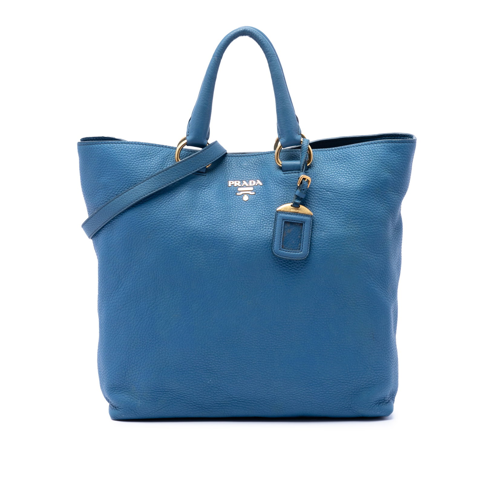 Prada Vitello Daino leather satchel with shoulder strap blue: Prada Vitello Daino leather satchel with shoulder strap blue Prada Vitello Daino Open Convertible Tote in blue leather with rolled top handles and a detachable flat shoulder strap. The bag features an