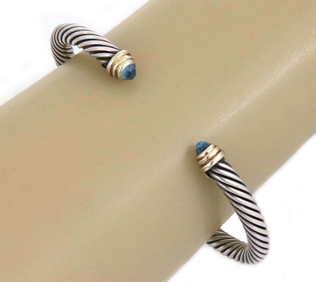David Yurman Cable Classic cuff bracelet blue topaz silver 14k gold: David Yurman Cable Classic cuff bracelet blue topaz silver 14k gold Pre-owned David Yurman Cable Classic cuff bracelet featuring the brand's signature twisted helix cable design with natural blue topa