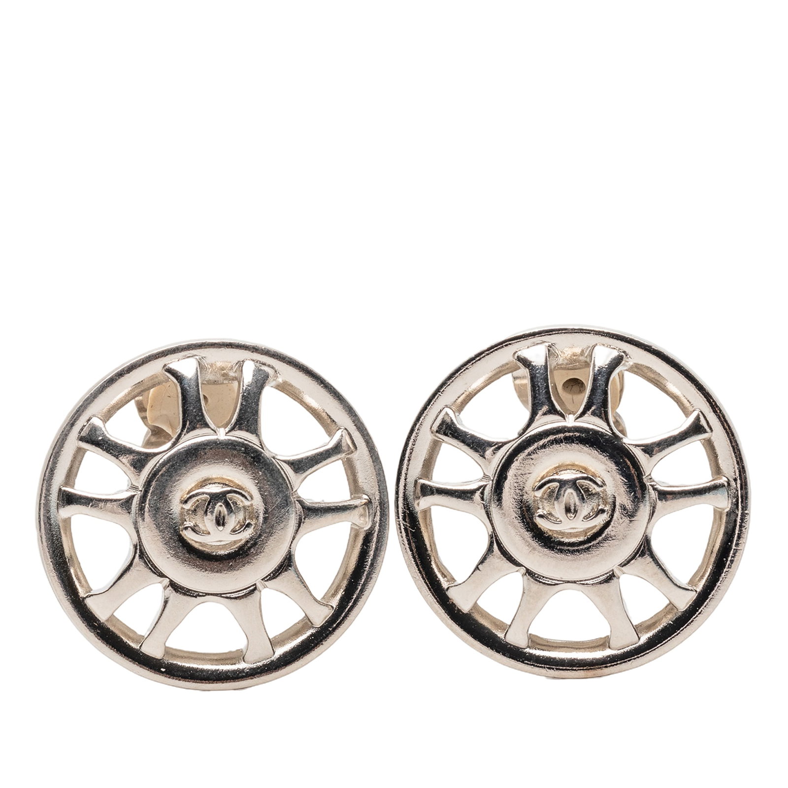 Chanel CC silver plated clip on wheel earrings: Chanel CC silver plated clip on wheel earrings These Chanel CC Silver Plated Wheel Clip On Earrings feature a silver plated metal construction with classic clip-on closures. Made in France, these cost