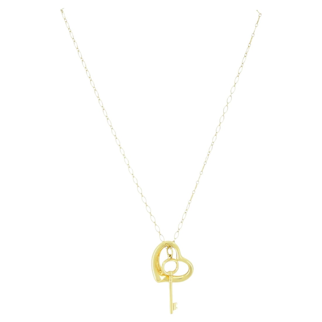Tiffany Co Elsa Peretti 18k Yellow Gold Open Heart Key Necklace: Tiffany Co Elsa Peretti 18k Yellow Gold Open Heart Key Necklace Elegant pendant necklace featuring an Open Heart charm paired with a Key charm on an elongated oval-link chain. Crafted in 18k yellow go