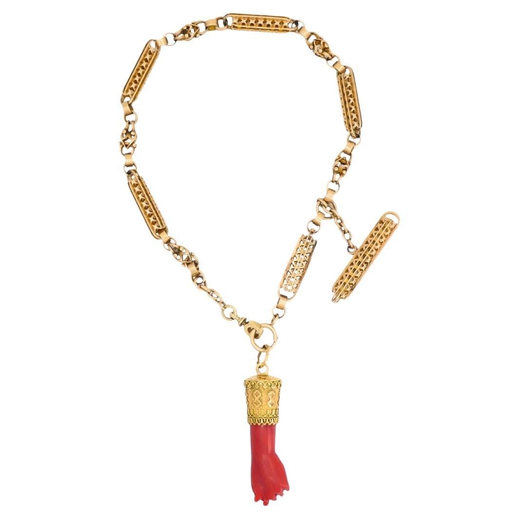 14k Gold Toggle Chain Necklace with Coral Figa Pendant Set of 2: 14k Gold Toggle Chain Necklace with Coral Figa Pendant Set of 2 Vintage necklace set featuring a 14k gold toggle chain and a coral figa pendant. The chain has elongated openwork links with filigree-li