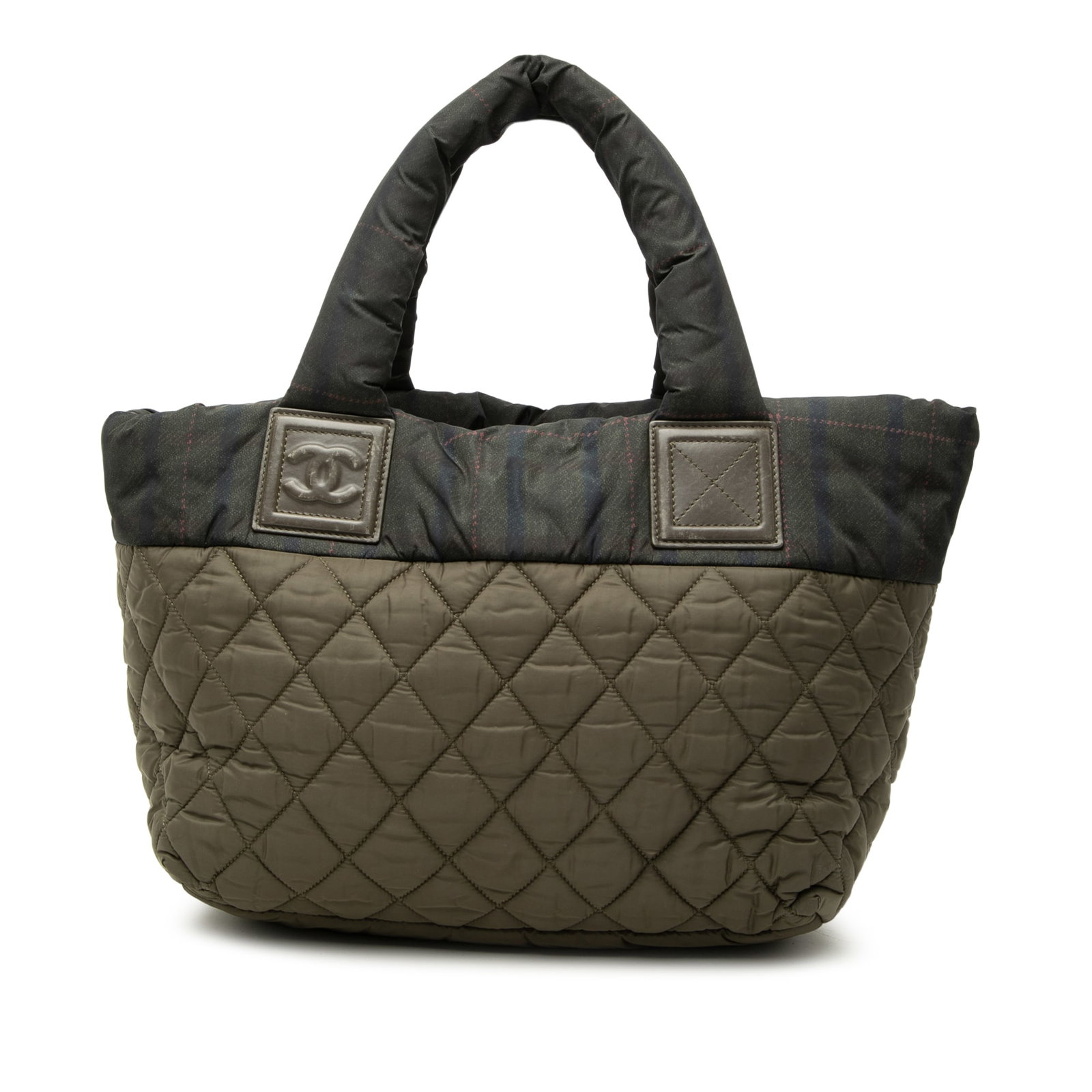 Chanel Coco Cocoon Small Quilted Nylon Tote Brown: Chanel Coco Cocoon Small Quilted Nylon Tote Brown Chanel Small Quilted Nylon Coco Cocoon Tote in brown with leather trim. This tote features a quilted fabric body, an exterior front zip pocket, rolled