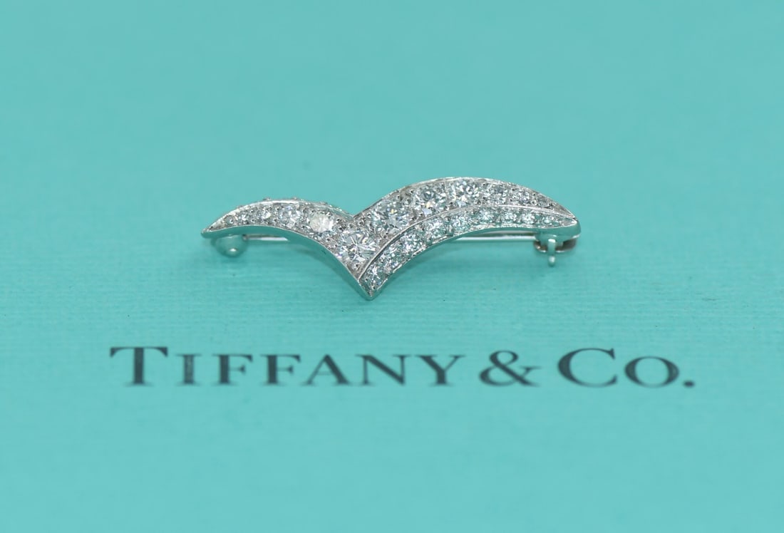 Platinum Seagull Pin with Diamond Accent by Tiffany & Co: Platinum Seagull Pin with Diamond Accent by Tiffany & Co This Tiffany & Co. pin features a seagull design crafted in platinum with 950 metal purity and is adorned with a diamond. The pin comes with a 