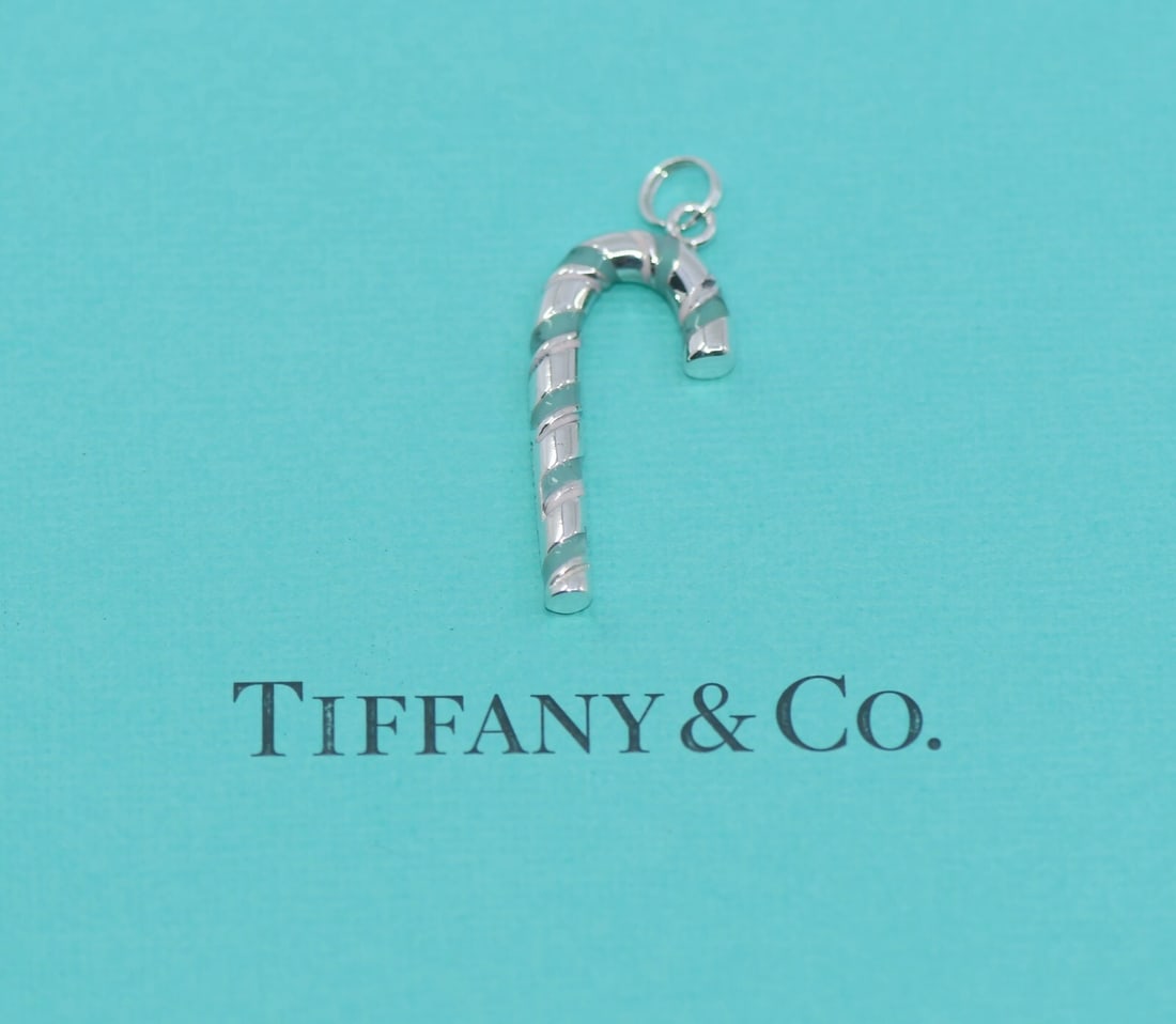 Tiffany & Co Candy Cane Sterling Silver Charm Pendant Authentic: Tiffany & Co Candy Cane Sterling Silver Charm Pendant Authentic This charming Tiffany & Co. Candy Cane pendant captures the festive spirit with its delightful design. Crafted from high-quality sterlin