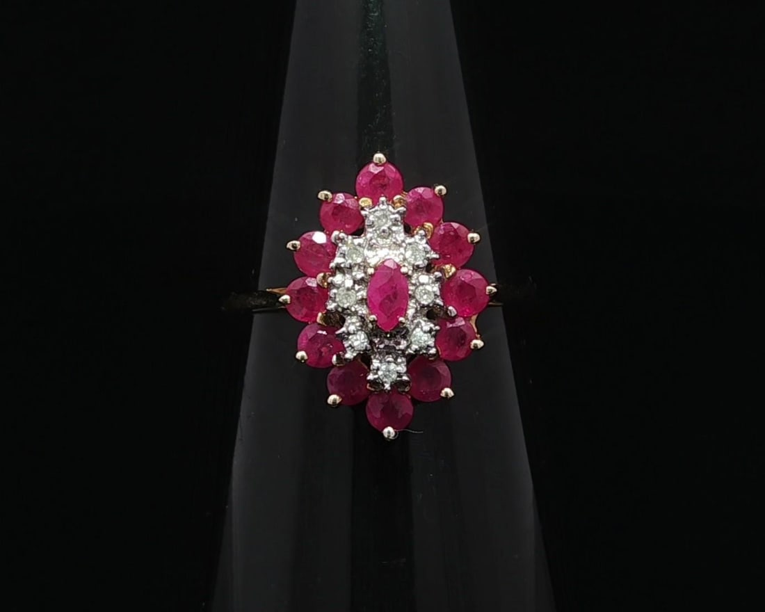 Vintage 10k Yellow Gold Ruby Diamond Cluster Marquise Ring: Vintage 10k Yellow Gold Ruby Diamond Cluster Marquise Ring This exquisite vintage ring showcases a stunning cluster of natural gemstones, featuring a marquise-shaped ruby complemented by round-cut dia