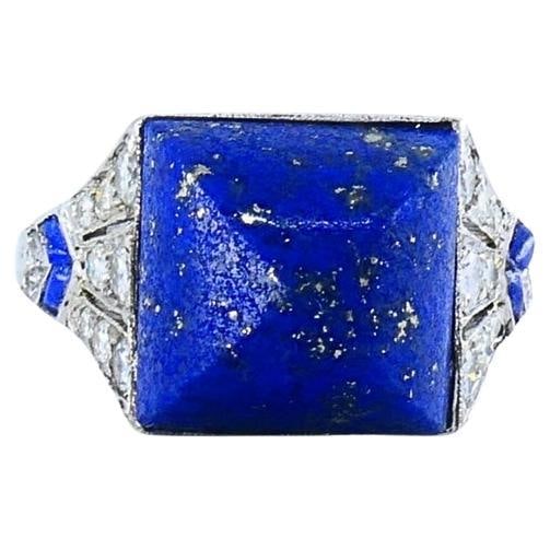 Cartier platinum Art Deco ring with lapis lazuli and diamonds: Cartier platinum Art Deco ring with lapis lazuli and diamonds Art Deco Cartier ring from the 1920s featuring lapis lazuli and diamond accents in platinum and 18k gold. The design centers on a sugarloa