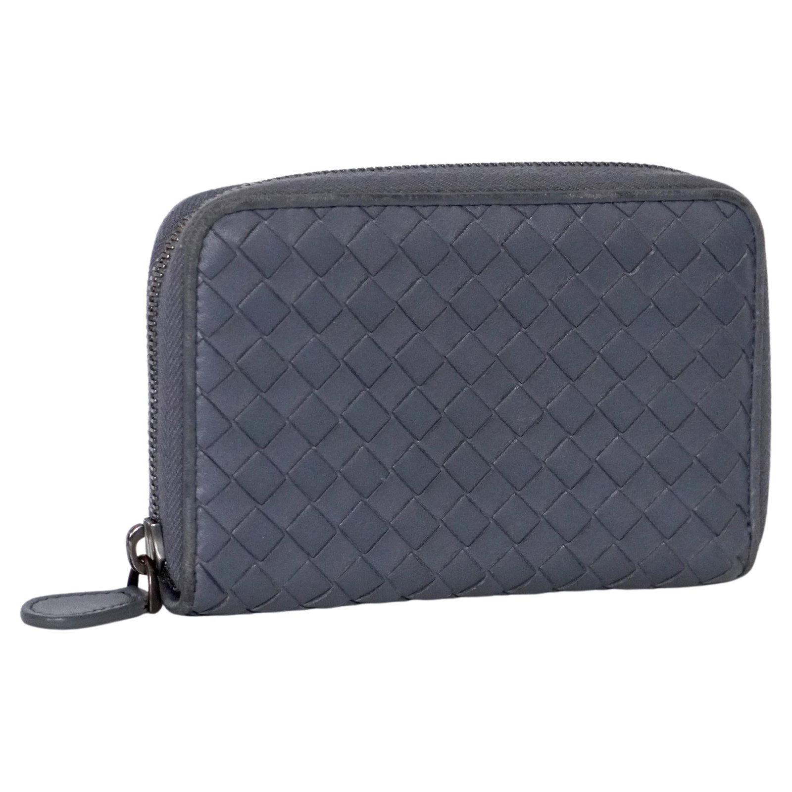Bottega Veneta Intrecciato Zip Around Leather Wallet Slate: Bottega Veneta Intrecciato Zip Around Leather Wallet Slate Bottega Veneta Intrecciato weave zip-around leather wallet in Slate, a pale blue shade. It features a top zip fastening, multiple interior ca
