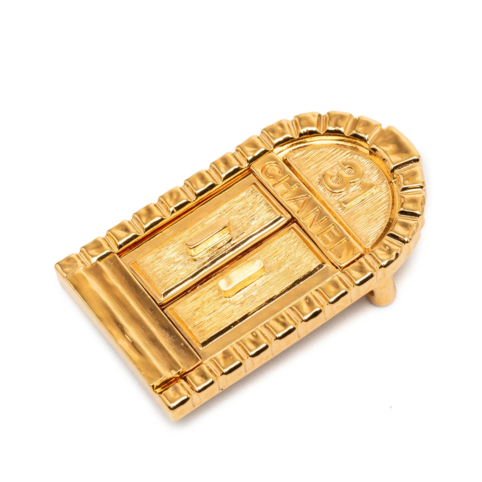Chanel gold tone metal door pin brooch 31 Rue Cambon: Chanel gold tone metal door pin brooch 31 Rue Cambon This Chanel brooch features a gold-tone metal body with a pin closure at the back. The piece is designed in the style of the 31 Rue Cambon Door and