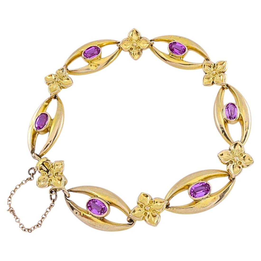 British 9k Gold Link Bracelet with Oval Pink Sapphires: British 9k Gold Link Bracelet with Oval Pink Sapphires A British bracelet crafted in 9k yellow gold and set with oval pink sapphires. It features elongated navette-shaped links with bezel-set stones, 